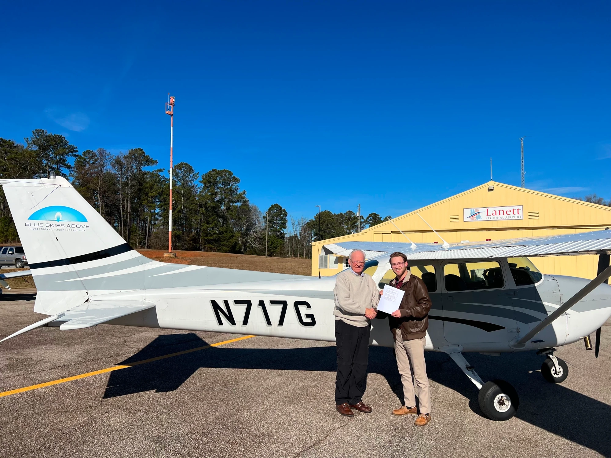 Blue Skies Above student pilot receiving his certificate after passing his checkride