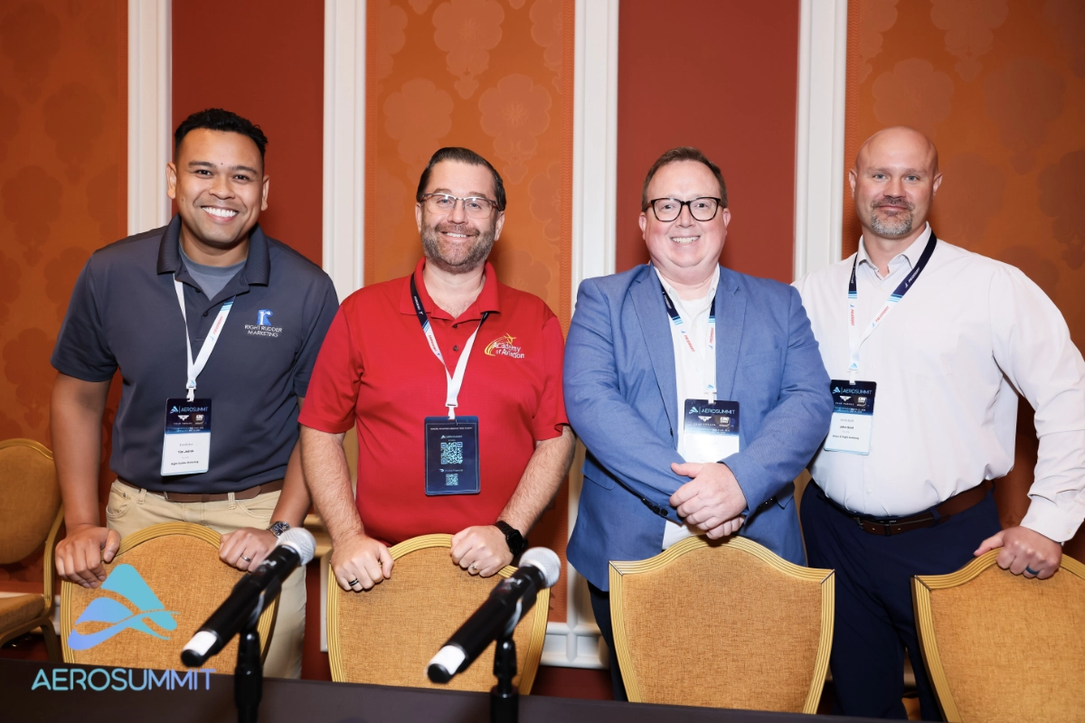 Tim Jedrek presenting Right Rudder Marketing's digital strategies at AeroSummit 2025, with a backdrop showcasing aviation-themed visuals.